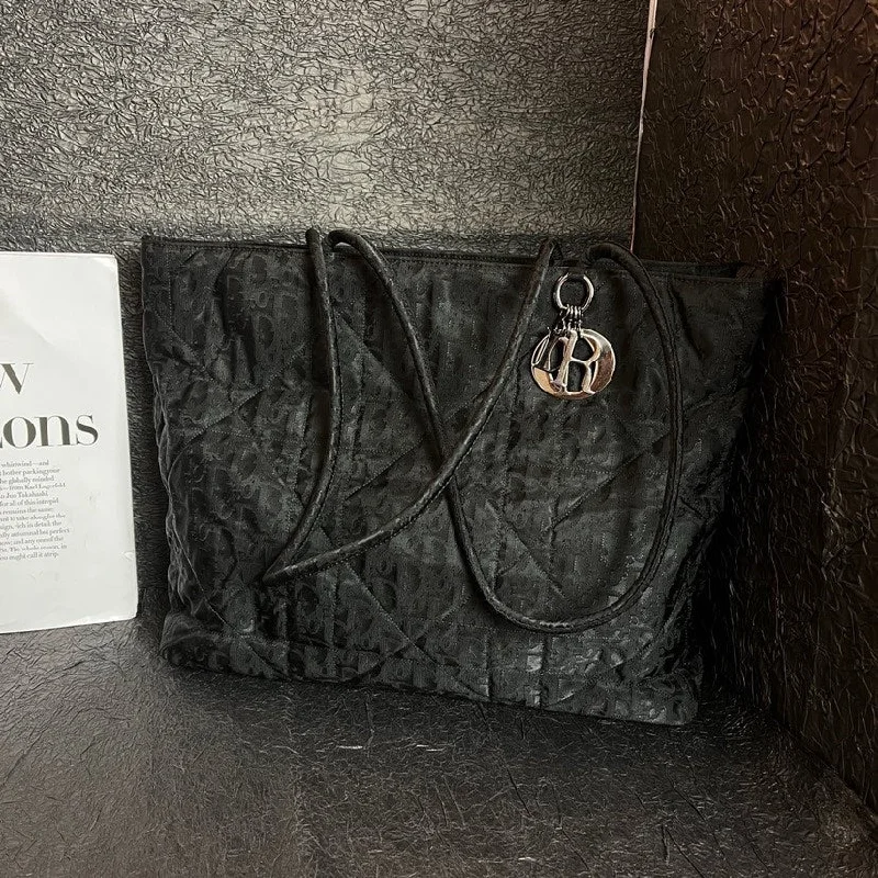 Christian Dior Saddle bags with a studded trim for a bold lookDior Black Canvas Logo Tote Bag 35cm